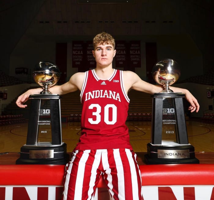 Indiana class of 2024 commit Liam McNeeley poses with Big Ten conference trophies during his official visit to Bloomington in September.